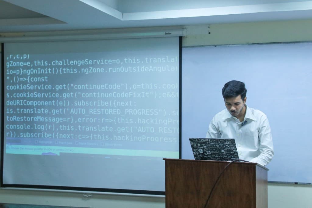 An engineering workshop with application code on screen
